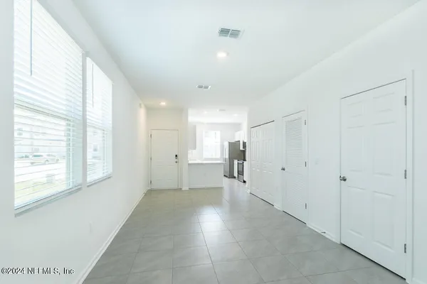 a view of a big room with windows and entryway