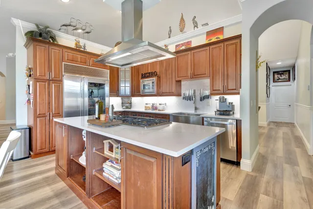 a kitchen with stainless steel appliances granite countertop a sink and a stove
