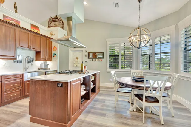 a kitchen with stainless steel appliances granite countertop a sink dishwasher stove and cabinets