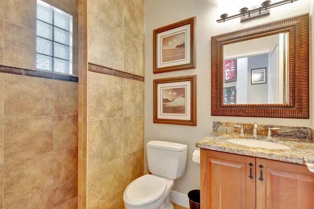 a en suite bathroom with a granite countertop tub and a sink