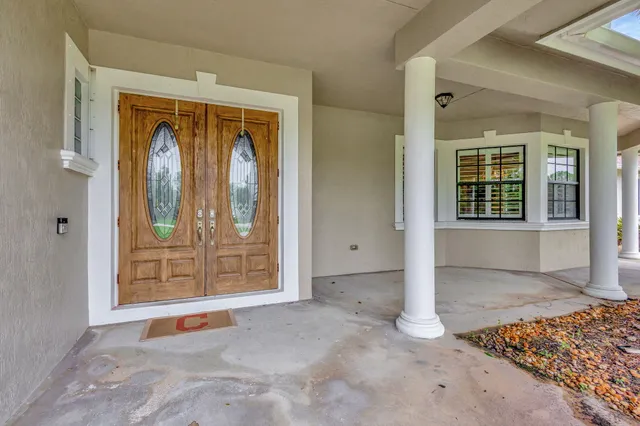 a living room with furniture kitchen view and a wooden floor
