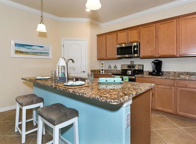 a kitchen with stainless steel appliances granite countertop a sink stove and microwave