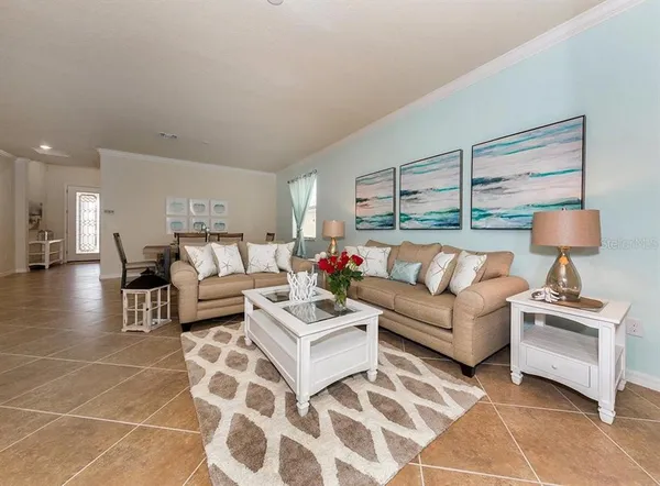 a living room with furniture and a lamp