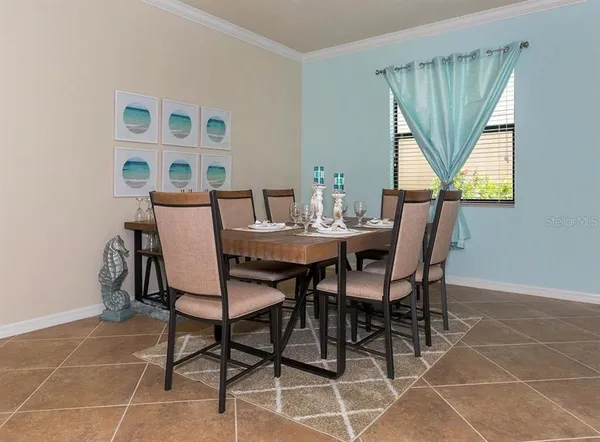 a view of a dining room with furniture and a window