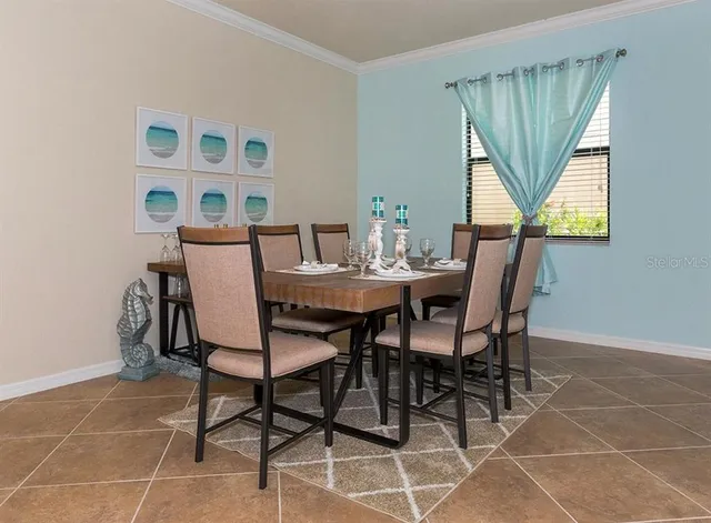 a view of a dining room with furniture and a window