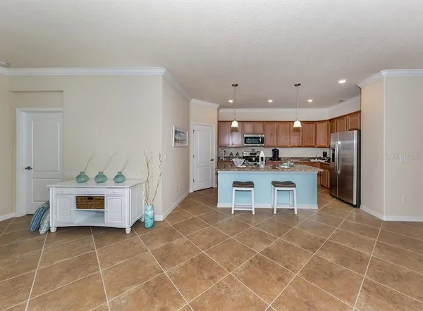 a kitchen with stainless steel appliances kitchen island granite countertop a sink and cabinets