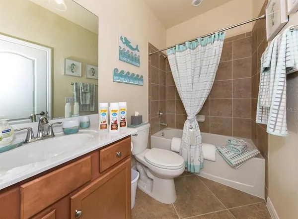 a bathroom with a sink a toilet and a shower