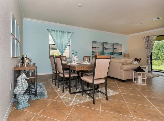 a dining room with furniture and window