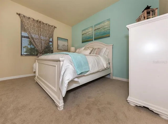 a bedroom with a bed and a cabinets