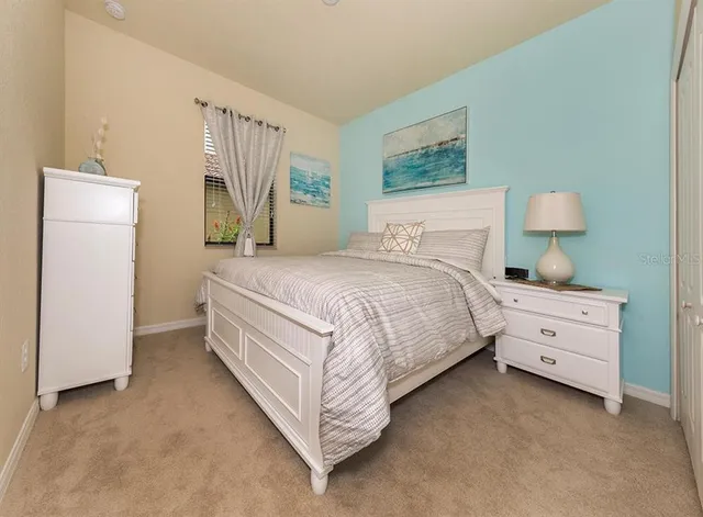 a bedroom with a bed and a night stand