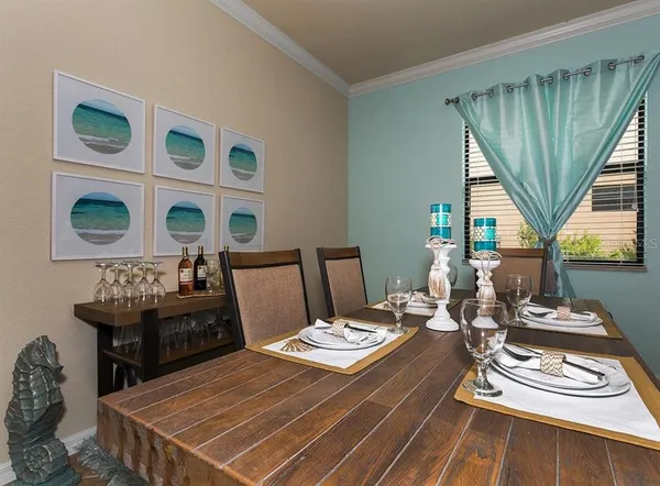 a living room with patio furniture and wooden floor