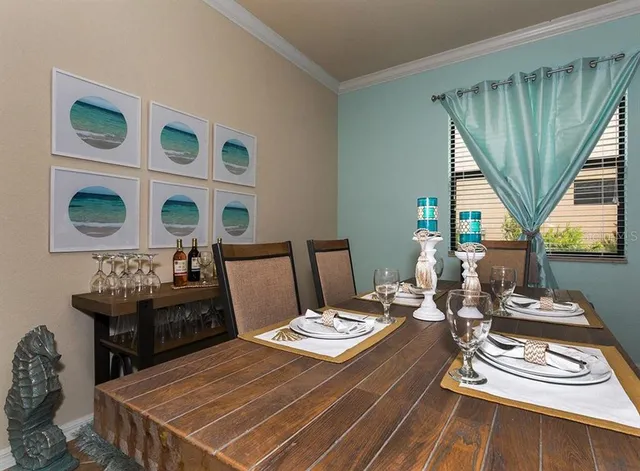 a living room with patio furniture and wooden floor