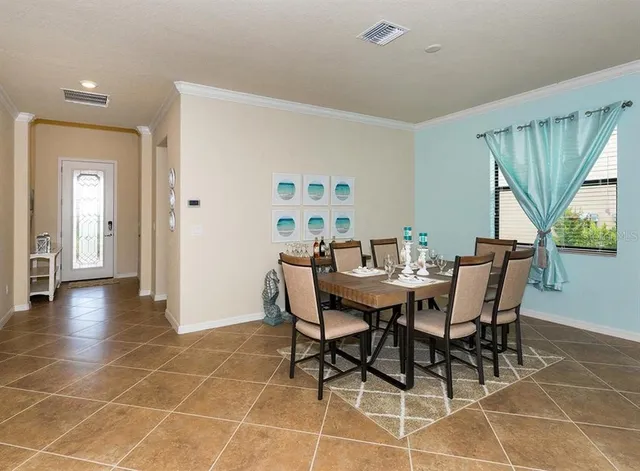 a dining room with furniture and window