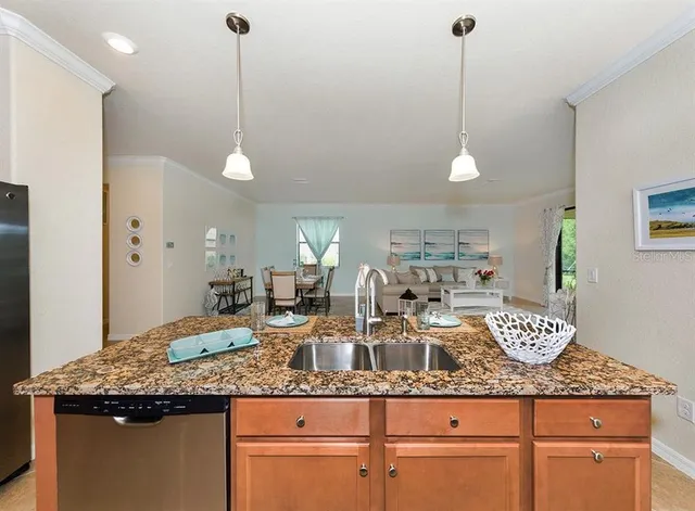a kitchen with granite countertop cabinets and white appliances