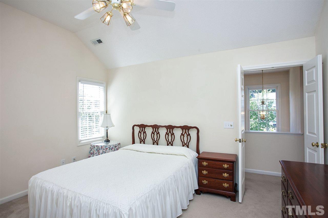 600 Hanska Way Raleigh, NC 27610 - Photo 11 of 18 a bedroom with a bed and a chandelier