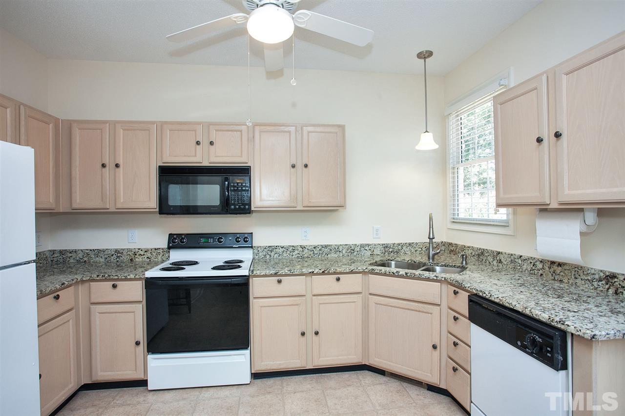 600 Hanska Way Raleigh, NC 27610 - Photo 4 of 18 a kitchen with granite countertop white cabinets white stainless steel appliances with a sink and dishwasher