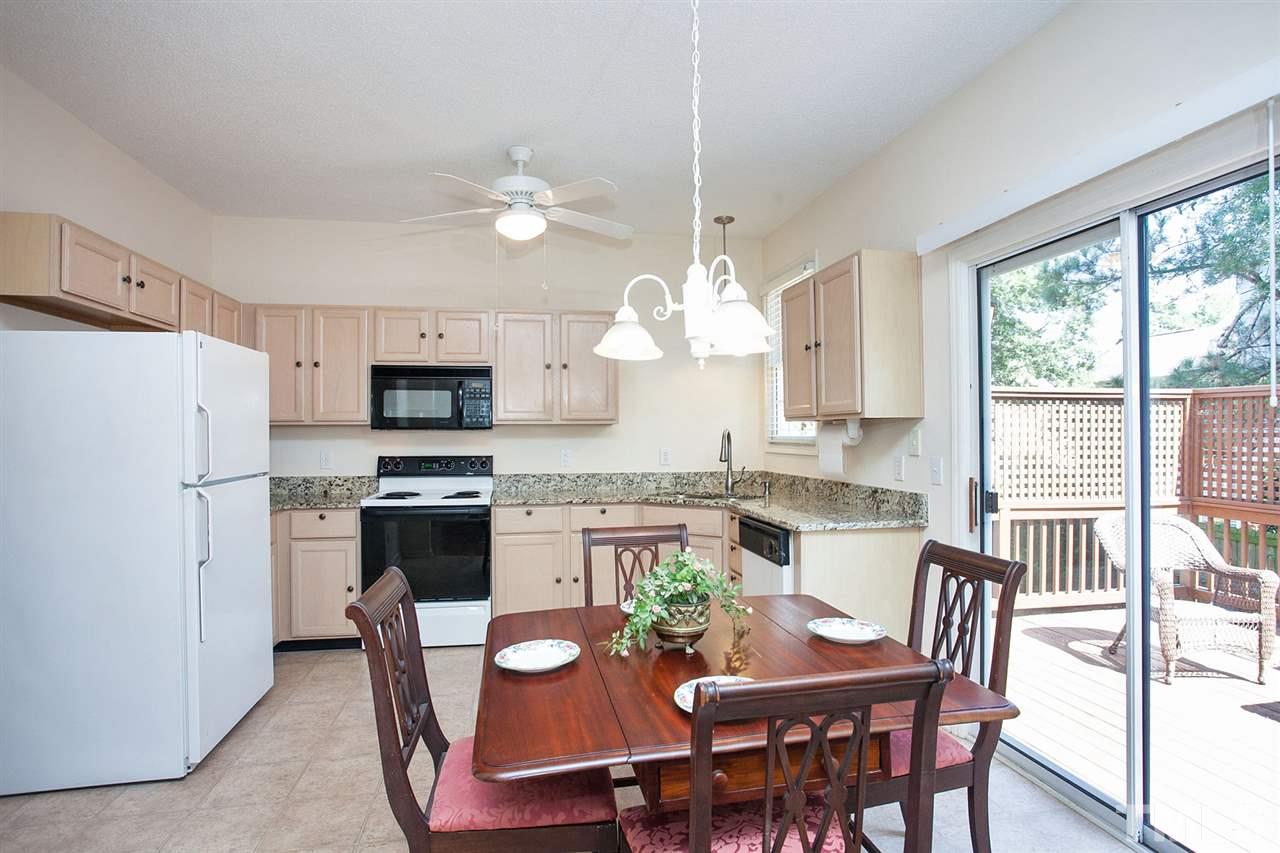 600 Hanska Way Raleigh, NC 27610 - Photo 5 of 18 a view of kitchen with refrigerator a stove a dining table and chairs