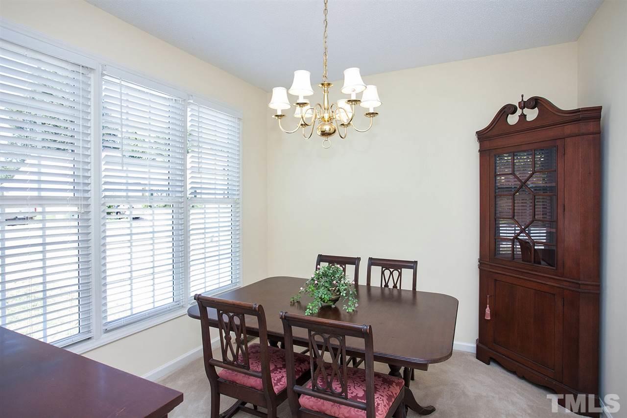 600 Hanska Way Raleigh, NC 27610 - Photo 8 of 18 a dining room with furniture a window and a chandelier