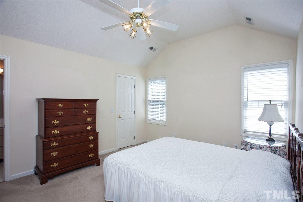 600 Hanska Way Raleigh, NC 27610 - Photo 10 of 18 a bedroom with a bed a chandelier and a window