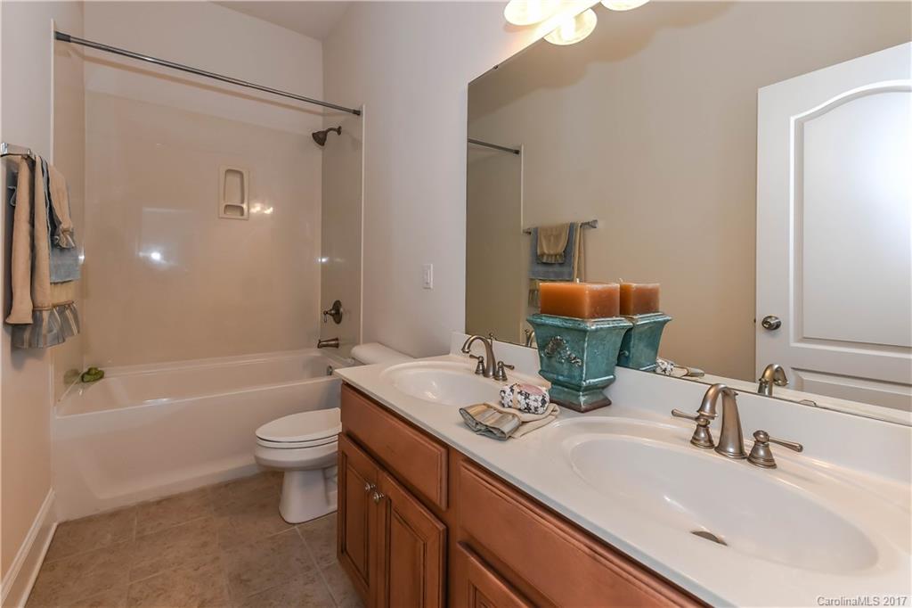 10944 Round Rock Road Charlotte, NC 28277 - Photo 20 of 23 a bathroom with a double vanity sink toilet mirror and bathtub