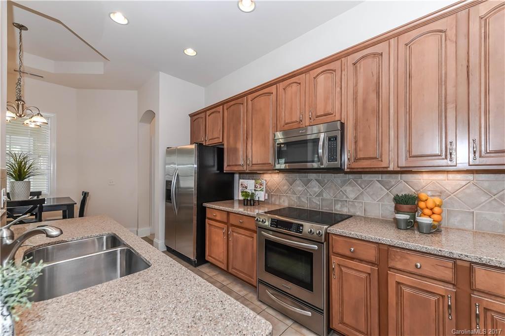 10944 Round Rock Road Charlotte, NC 28277 - Photo 8 of 23 a kitchen with granite countertop a sink stainless steel appliances and cabinets