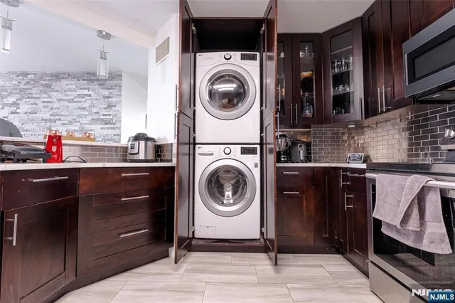 a utility room with sink dryer and washer