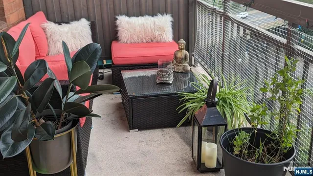 a view of balcony with a potted plant and outdoor seating