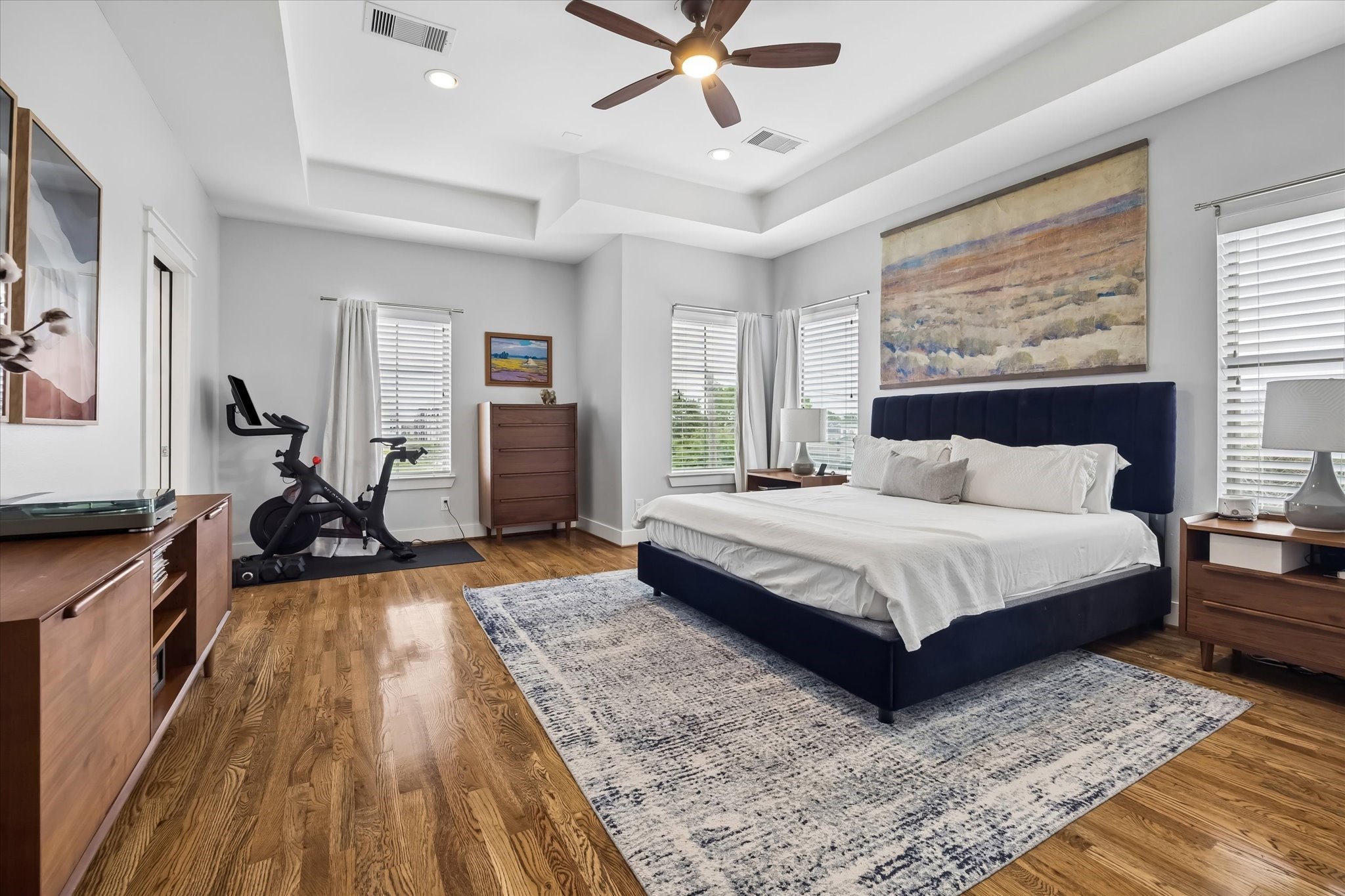 2503 Nicholson Street Houston, TX 77008 - Photo 11 of 22 The primary suite benefits from the natural light being on a corner brings. A coffered ceiling, hardwood floors and recessed lighting bring beauty to this spacious retreat. Two oversized walk-in closets add to the appeal of this grand space.