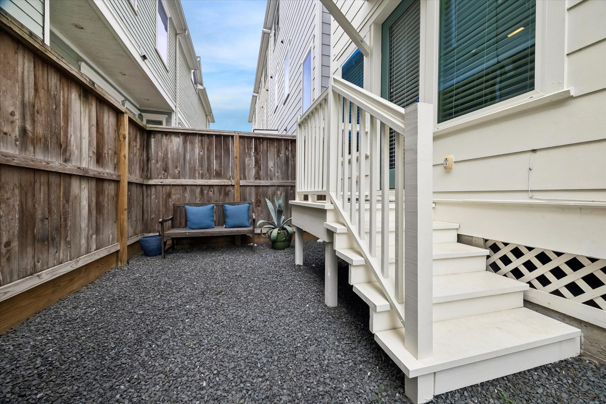 2503 Nicholson Street Houston, TX 77008 - Photo 20 of 22 Outdoor space on the back side of the home has been hardscaped with black star gravel for visual appeal and easy maintenance. Steps lead to door accessing the first floor bedroom.