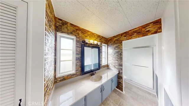 a bathroom with a tub a sink and mirror