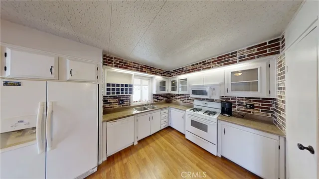 a kitchen with stainless steel appliances granite countertop a stove and a refrigerator