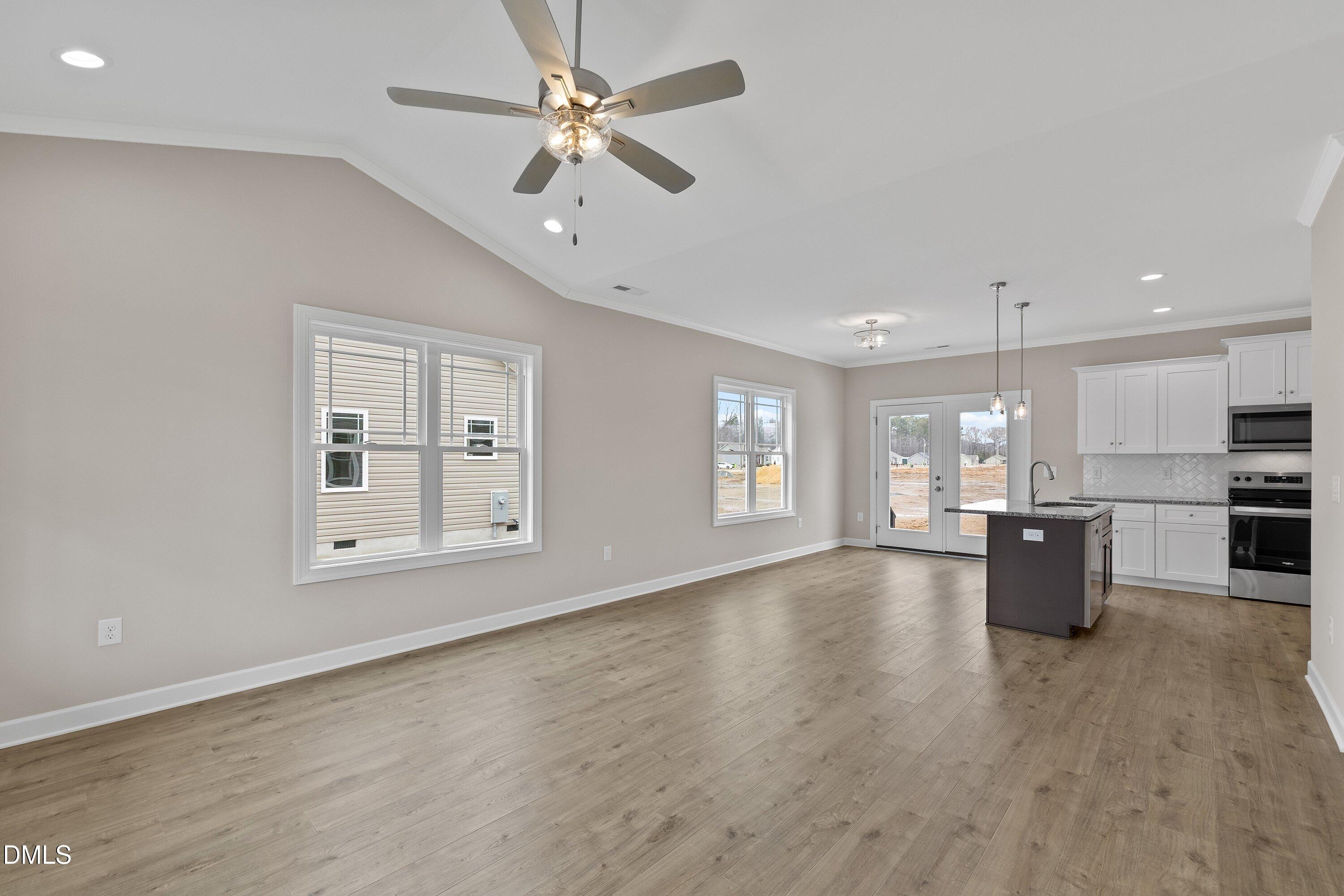 926 Micro Road West Selma, NC 27576 - Photo 9 of 41 a view of an empty room with a window and wooden floor
