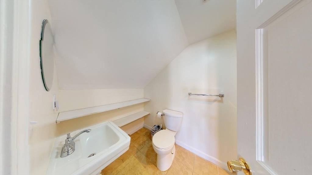 17 Gorham Road, Unit 2 Medford, MA 02155 - Photo 26 of 37 a bathroom with a granite countertop toilet and a sink