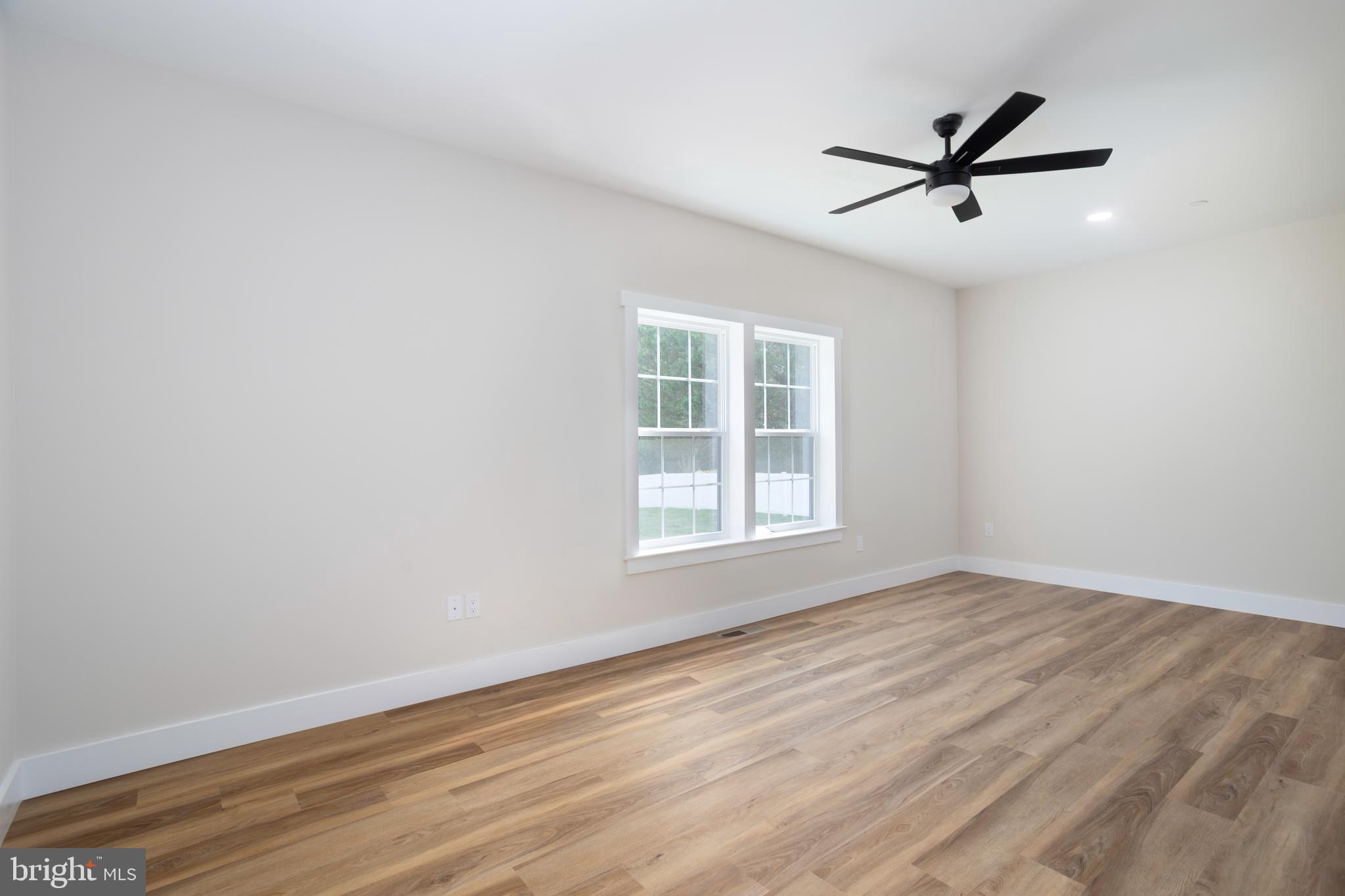 Clark Corner Road Centreville, MD 21617 - Photo 14 of 43 a view of empty room with wooden floor and fan