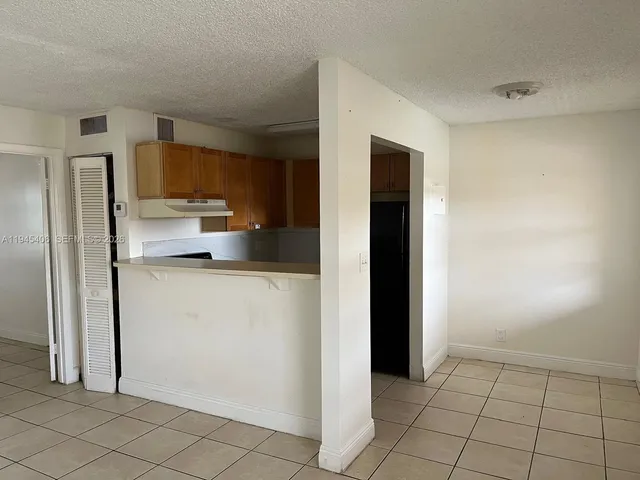 a kitchen with a refrigerator stove and cabinets
