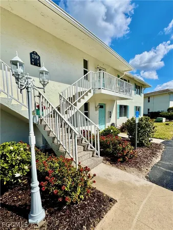 a front view of house along with deck and outdoor seating