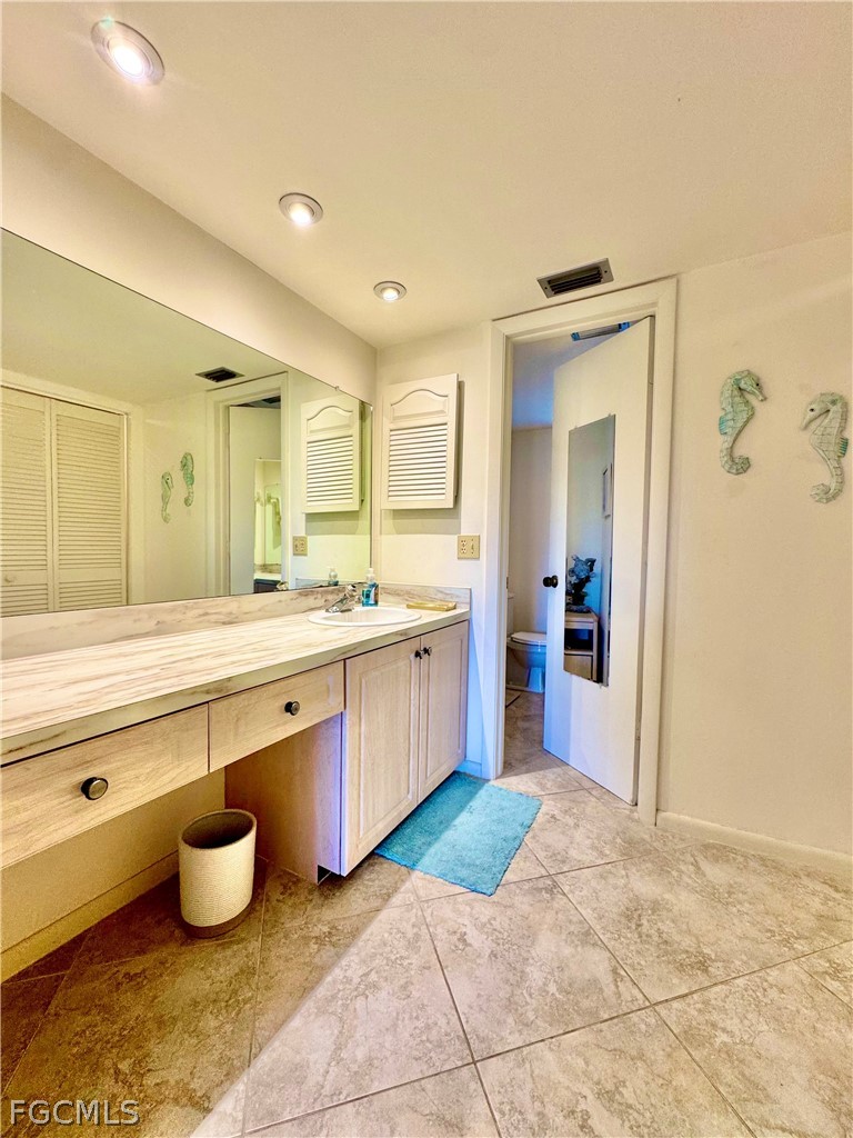 159 Quails Nest Road, Unit 2 Naples, FL 34112 - Photo 11 of 17 a large bathroom with a tub sink and mirror