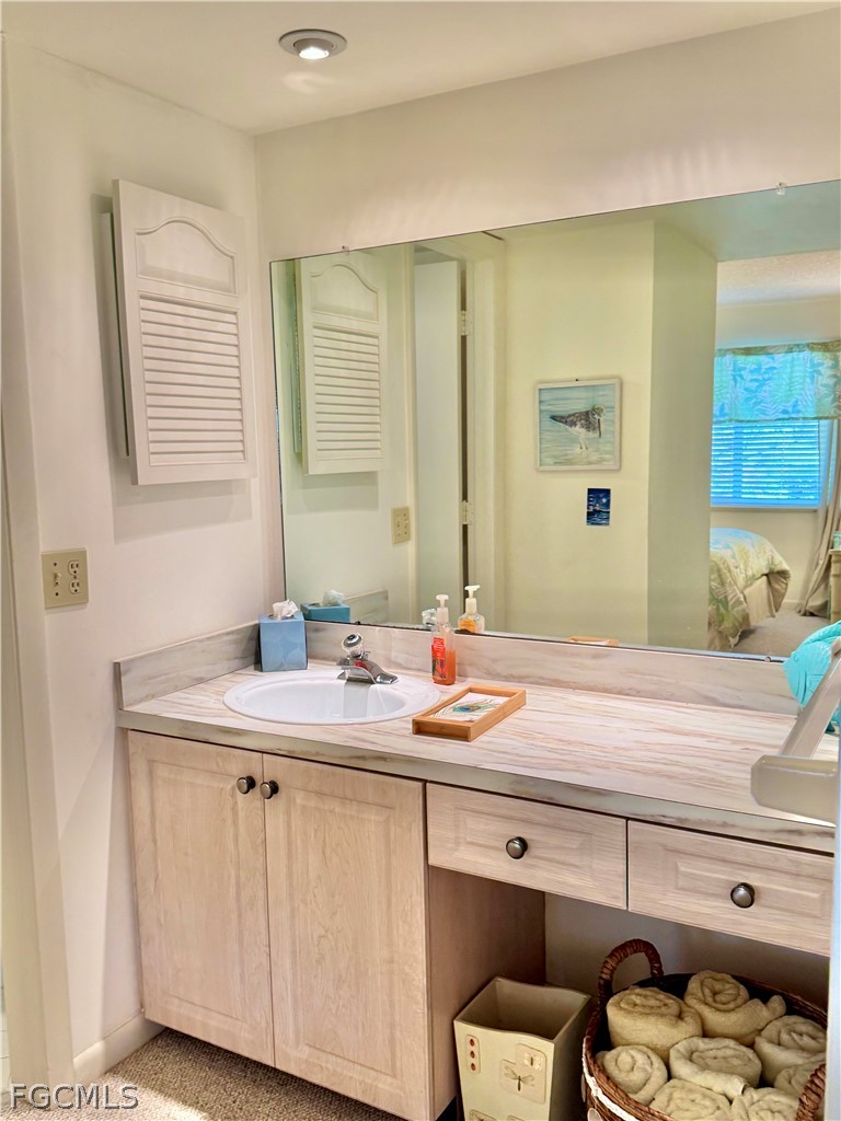 159 Quails Nest Road, Unit 2 Naples, FL 34112 - Photo 12 of 17 a bathroom with a granite countertop sink and a mirror