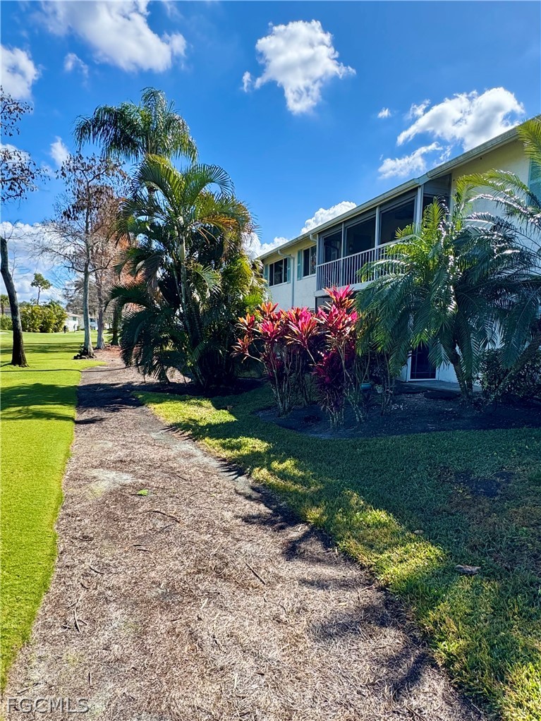 159 Quails Nest Road, Unit 2 Naples, FL 34112 - Photo 17 of 17 a view of a house with a swimming pool and garden
