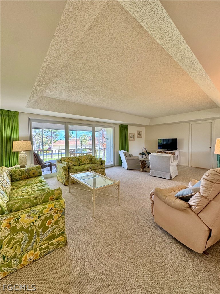 159 Quails Nest Road, Unit 2 Naples, FL 34112 - Photo 4 of 17 a living room with furniture and wooden floor