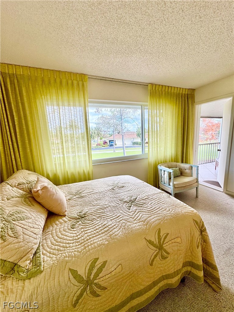 159 Quails Nest Road, Unit 2 Naples, FL 34112 - Photo 7 of 17 a bedroom with a bed and wooden floor