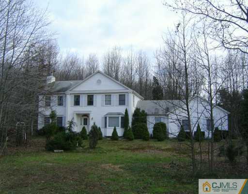 23 Butcher Road Monroe Township, NJ 08831 - Photo 2 of 7 a front view of a house with a garden