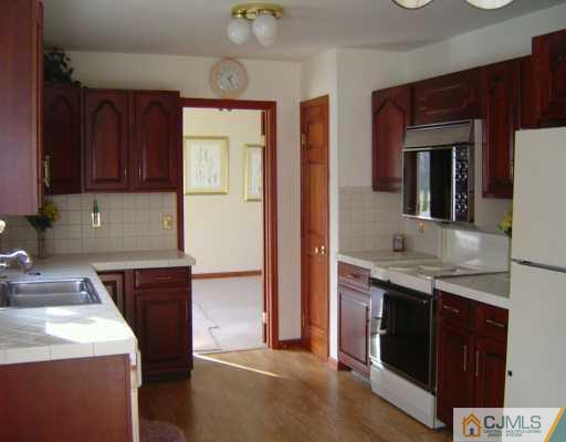 23 Butcher Road Monroe Township, NJ 08831 - Photo 4 of 7 a kitchen with stainless steel appliances granite countertop a stove and a sink