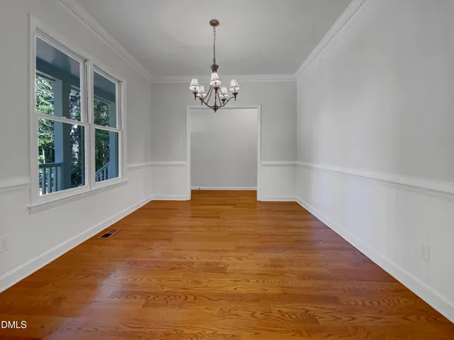 a view of wooden floor in an empty room