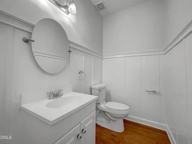 a bathroom with a sink toilet and a mirror