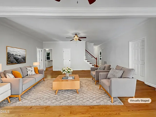 a living room with furniture and wooden floor