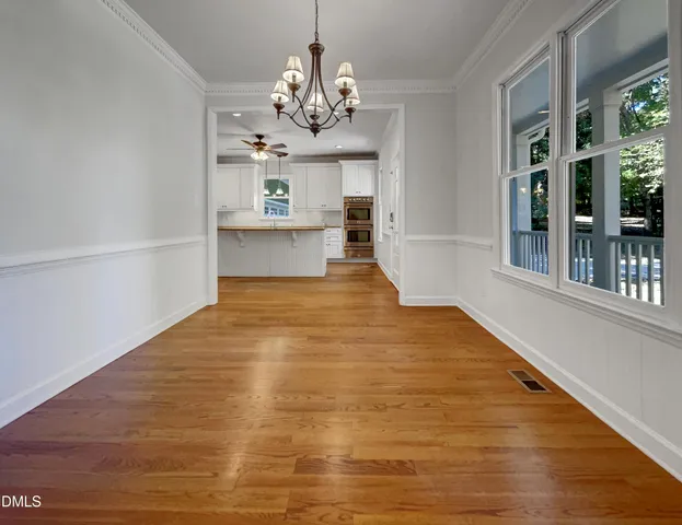 a view of a room with wooden floor and large windows