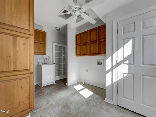 a view of a kitchen with an entryway and chandelier