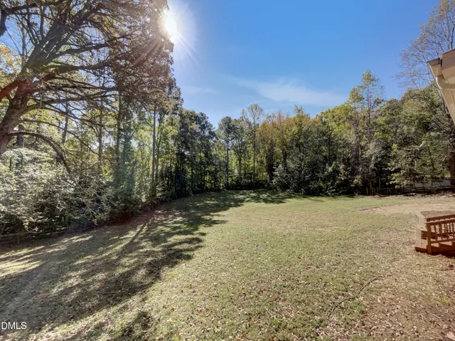 a view of backyard with large trees