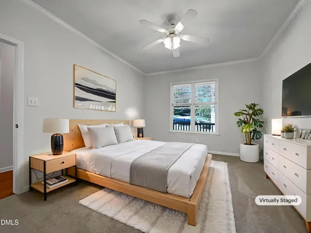 a bedroom with a bed chandelier and window